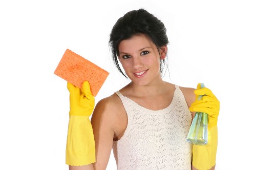 Cleaner vacuuming and dusting a modern SE1 living room